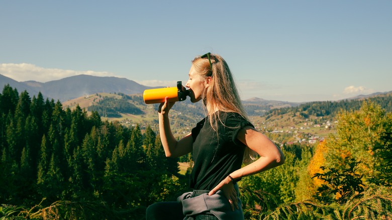 Woman drinking water on a hike
