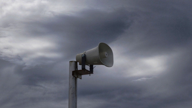 Tornado siren against stormy skies