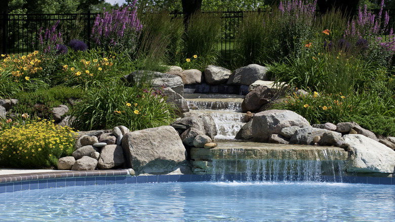 rock waterfall feature in a swimming pool