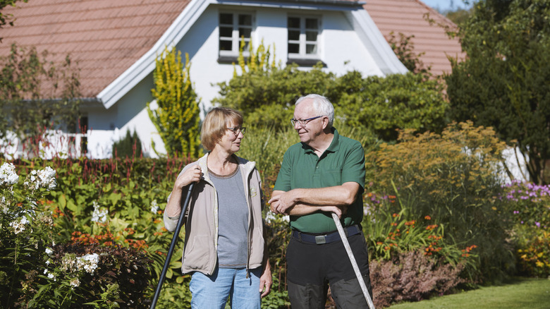 Couple standing in front of their wildflower garden
