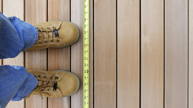 A measuring tape on decking boards