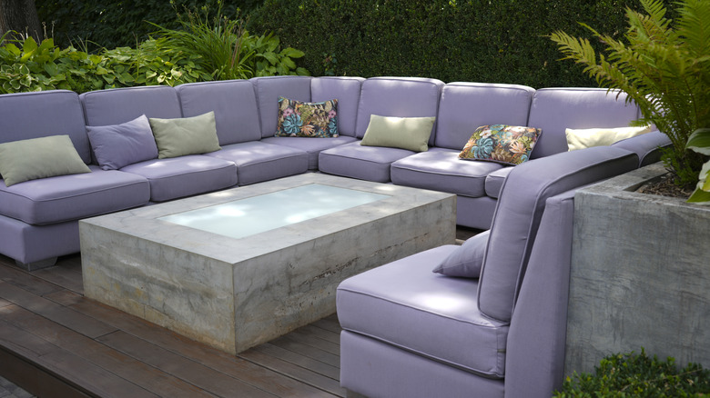 A large lilac upholstered outdoor sofa