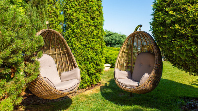 Two egg chairs in a secluded garden spot
