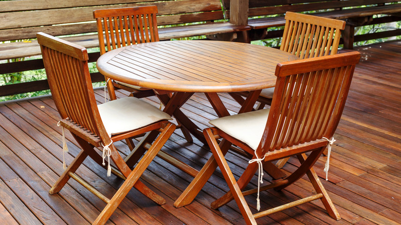 A round teak table with matching chairs