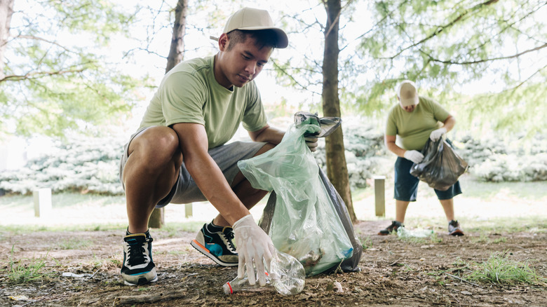 A group of park maintenance workers picking up trash