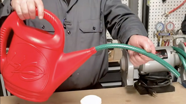 man with extended watering can