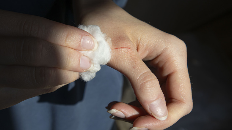 Small cut on hand beneath thumb