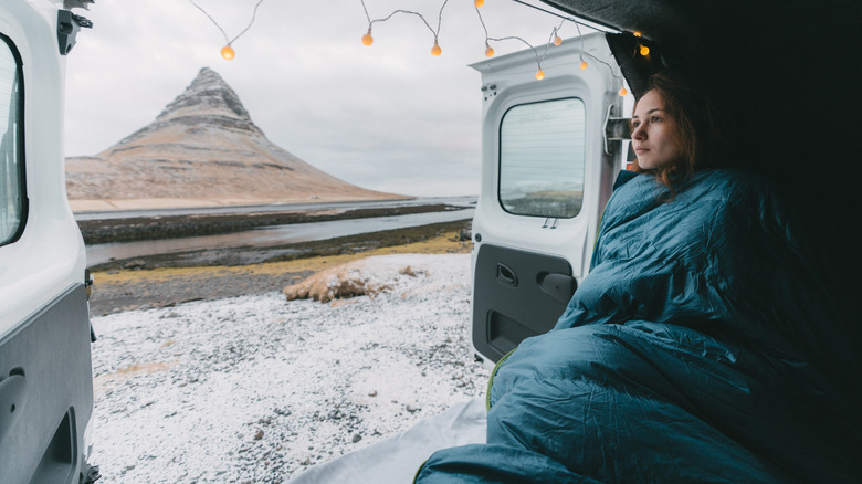 Woman in sleeping bag in cold weather