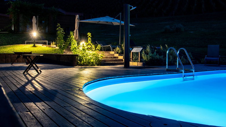 An outdoor swimming pool illuminated by a waterproof light