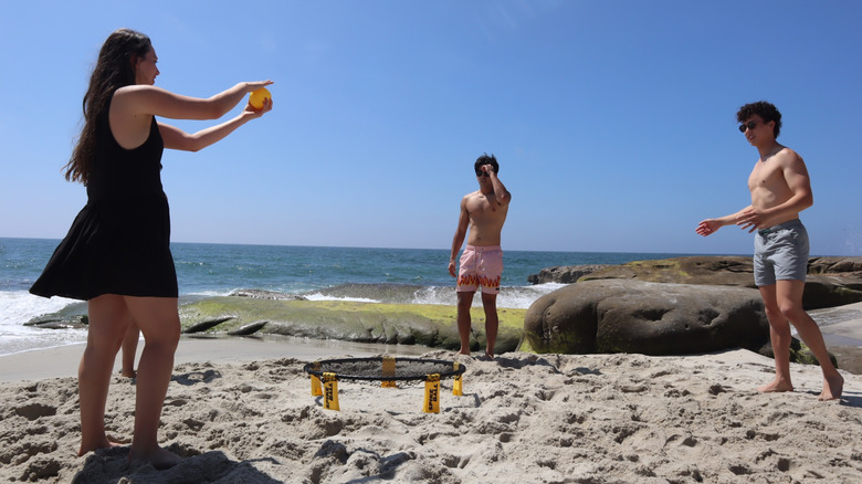 People playing roundnet on the beach