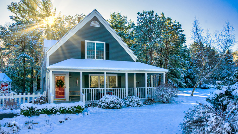 House with snowy lawn at sunrise