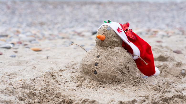 Snowman made of sand on the beach
