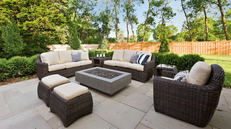 An outdoor patio with furniture around a fire pit