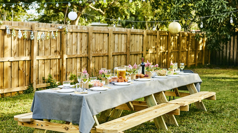 Backyard birthday party with treated wooden fence in the background