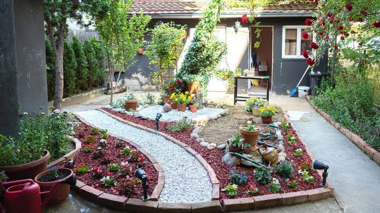 A garden with a white gravel path running through the middle