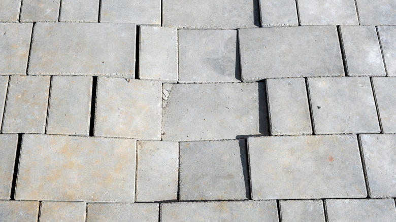 Broken and uneven pavers pressed together