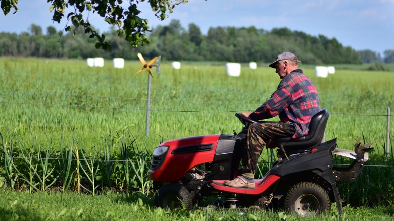 A man operating a riding mower