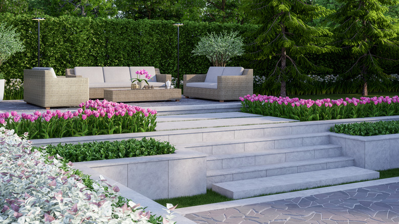 a beautiful tiered patio on a sloped backyard
