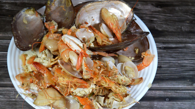 Leftover seafood shells on a white plate