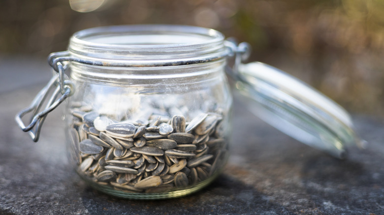 An open jar of sunflower seeds on a table