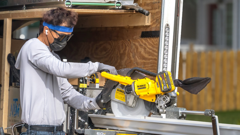 Man using DeWalt mitre saw