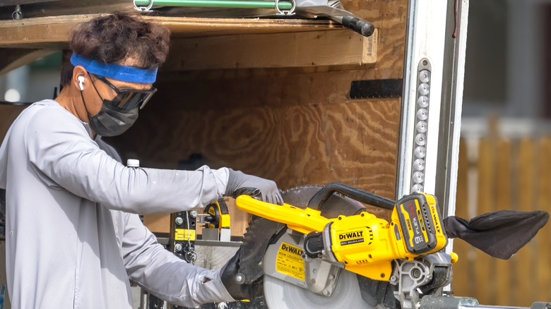 Man using DeWalt mitre saw