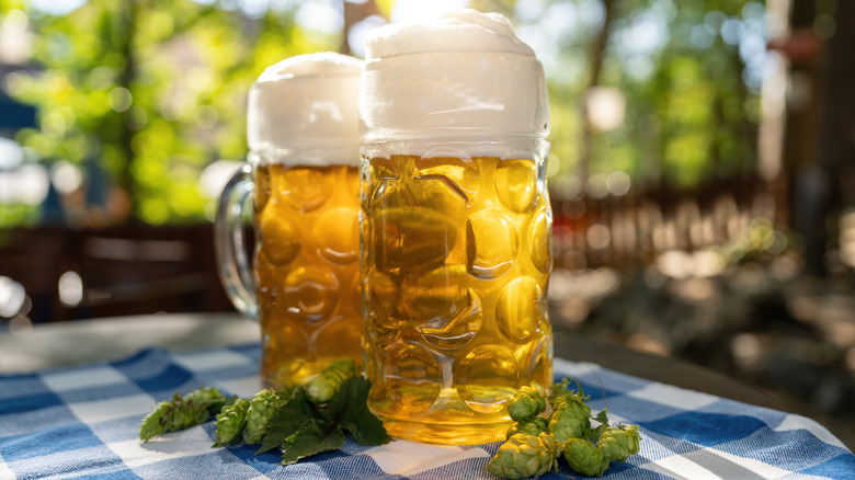 Mugs of beer on table outside