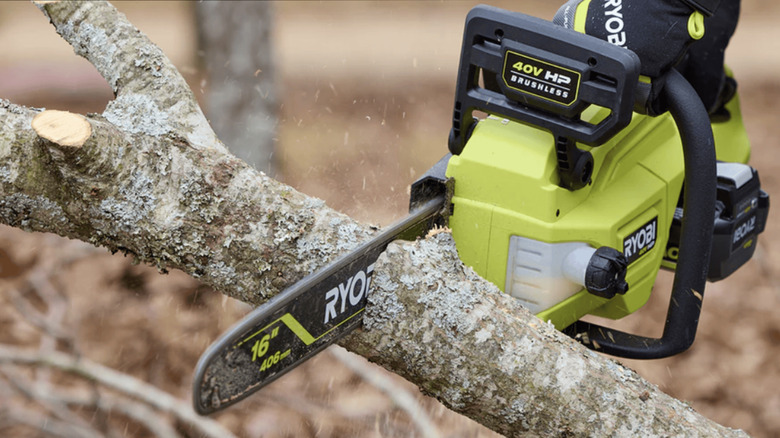 Ryobi 40V 16-inch chainsaw cutting through a large branch