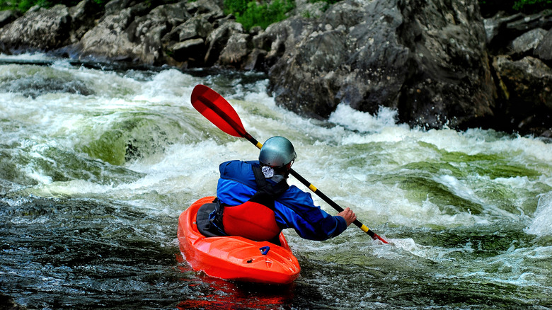 Kayaker bracing in whitewater
