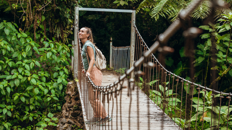 Woman looking over bridge in Costa Rica