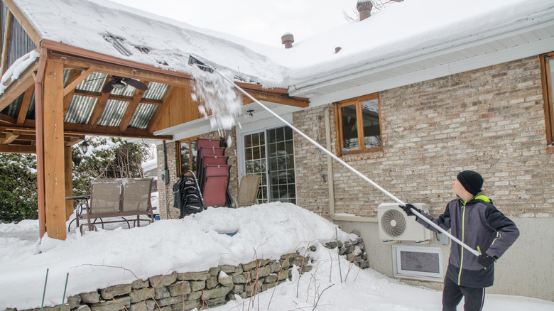 Clearing snow with roof rake
