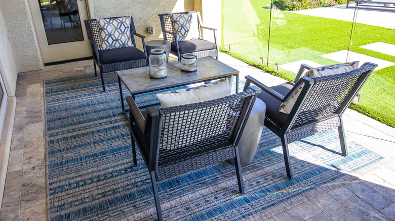 Blue patio rug with chairs